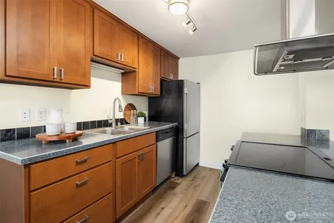 a kitchen with sink stove and microwave