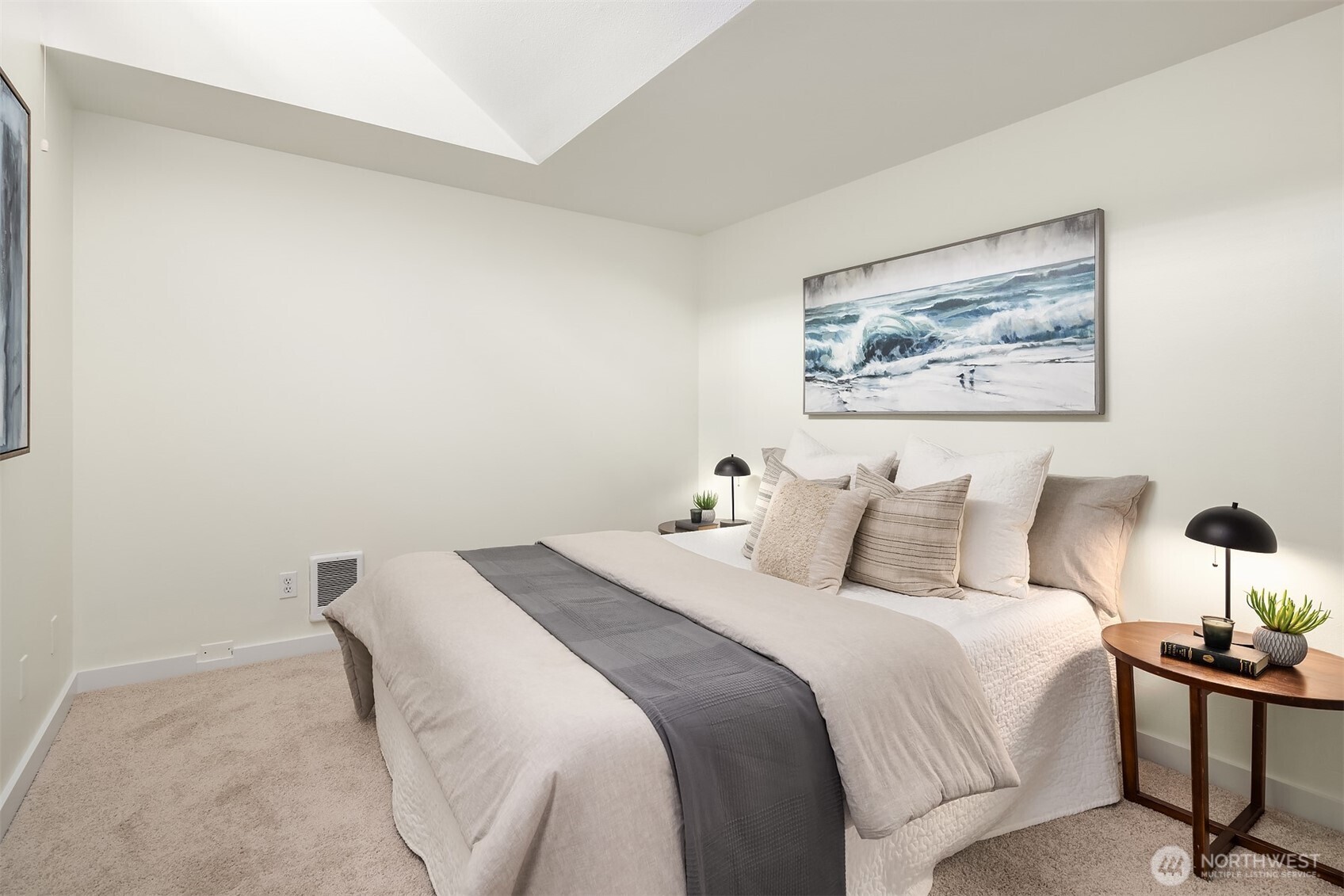 1730 Taylor Avenue North, Unit 409 Seattle, WA 98109 - Photo 7 of 22 a bedroom with a bed and a painting on the wall