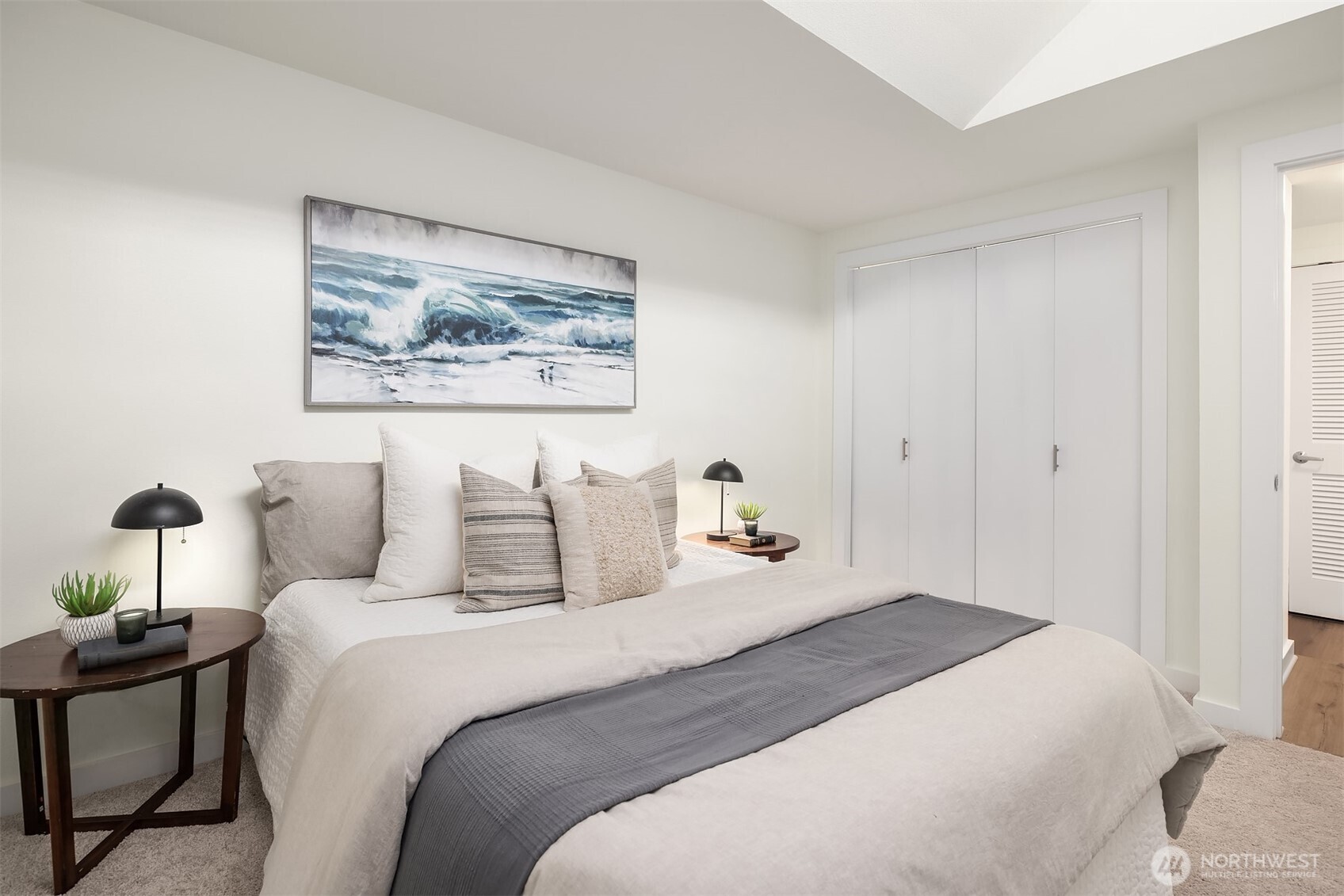 1730 Taylor Avenue North, Unit 409 Seattle, WA 98109 - Photo 8 of 22 a bedroom with a bed and a painting on the wall