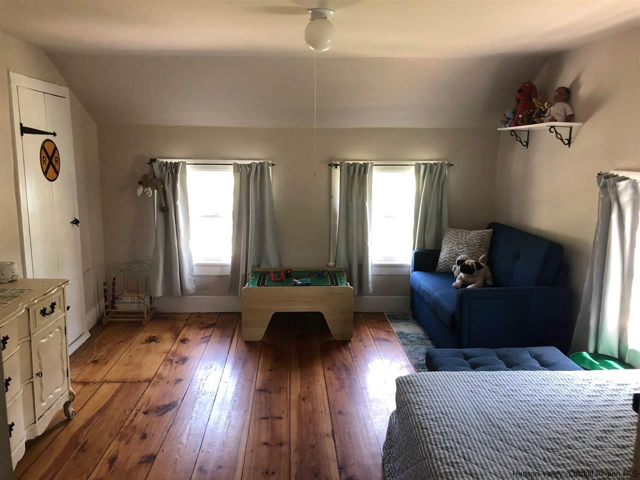 8 George Sickle Road, Unit 8 Saugerties, NY 12477 - Photo 18 of 24 a bedroom with furniture and wooden floor