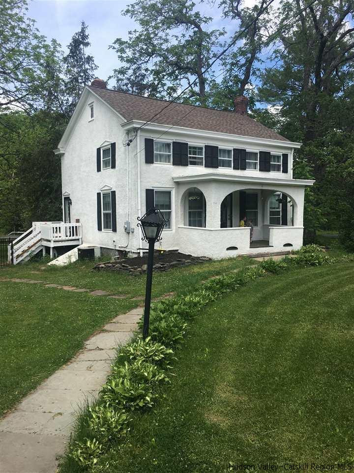 8 George Sickle Road, Unit 8 Saugerties, NY 12477 - Photo 2 of 24 a front view of a house with a yard table and chairs