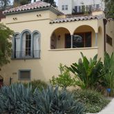 a view of a house with potted plants