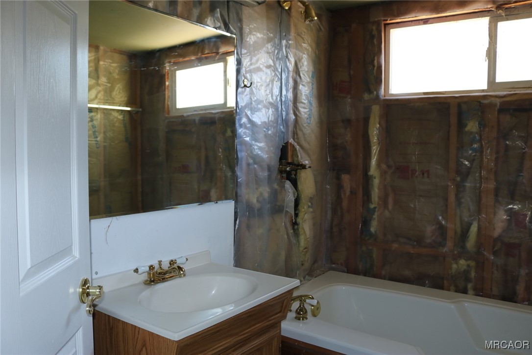 1247 Piney Ridge Place Fawnskin, CA 92333 - Photo 18 of 37 a bathroom with a sink and a mirror
