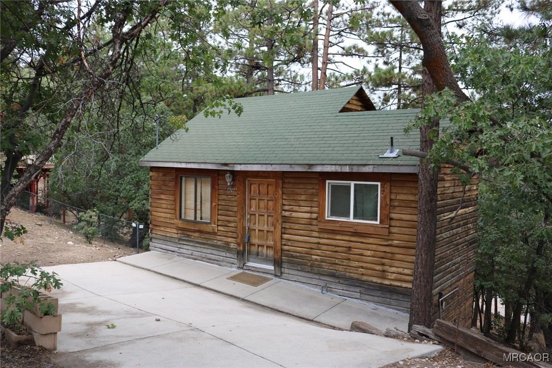 1247 Piney Ridge Place Fawnskin, CA 92333 - Photo 2 of 37 a front view of a house with a yard
