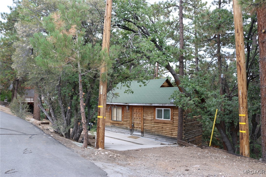1247 Piney Ridge Place Fawnskin, CA 92333 - Photo 36 of 37 a view of a house with a tree and wooden fence