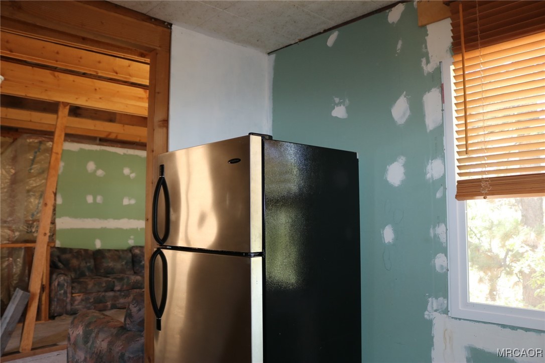 1247 Piney Ridge Place Fawnskin, CA 92333 - Photo 6 of 37 a refrigerator freezer sitting inside of a kitchen