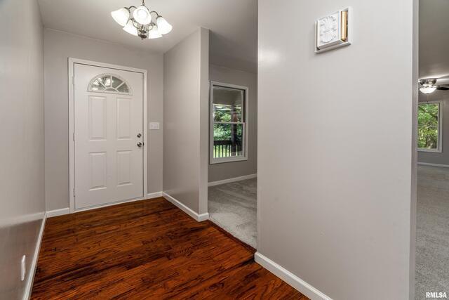 17937 Caplinger Pond Road Marion, IL 62959 - Photo 12 of 43 a view of a hallway with wooden floor and a chandelier