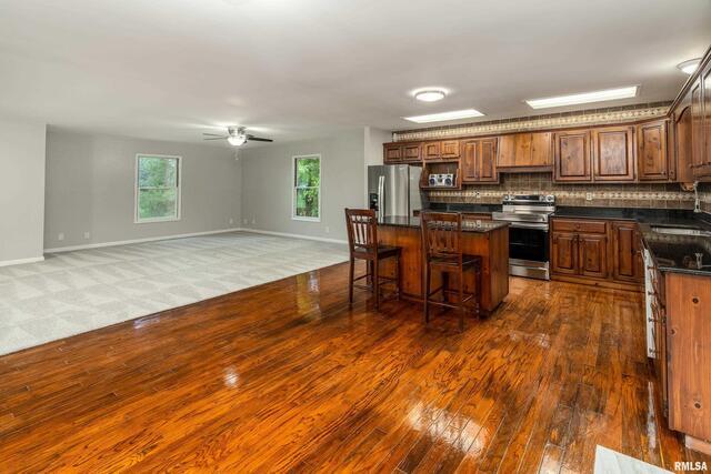 17937 Caplinger Pond Road Marion, IL 62959 - Photo 15 of 43 a kitchen with stainless steel appliances granite countertop a stove and a wooden floors