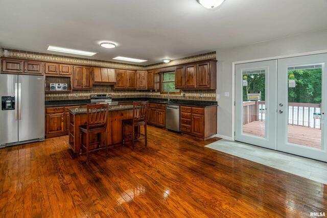 17937 Caplinger Pond Road Marion, IL 62959 - Photo 19 of 43 a kitchen with stainless steel appliances granite countertop a stove and a refrigerator