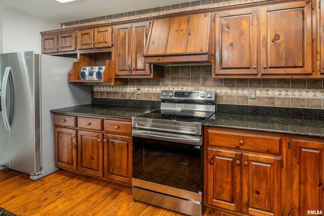 17937 Caplinger Pond Road Marion, IL 62959 - Photo 20 of 43 a kitchen with stainless steel appliances granite countertop a stove a sink and a microwave