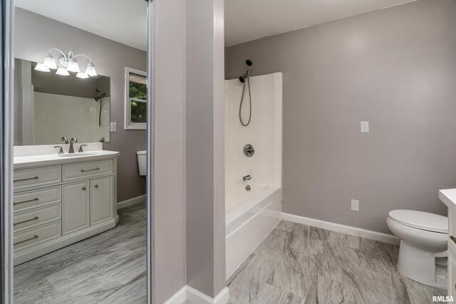 17937 Caplinger Pond Road Marion, IL 62959 - Photo 40 of 43 a bathroom with a sink a toilet a large mirror and shower
