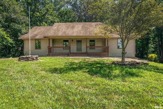 17937 Caplinger Pond Road Marion, IL 62959 - Photo 7 of 43 a view of a white house with a big yard and large tree