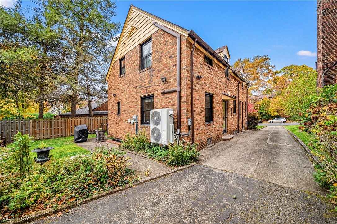 View of side of home featuring ac unit and a patio area
