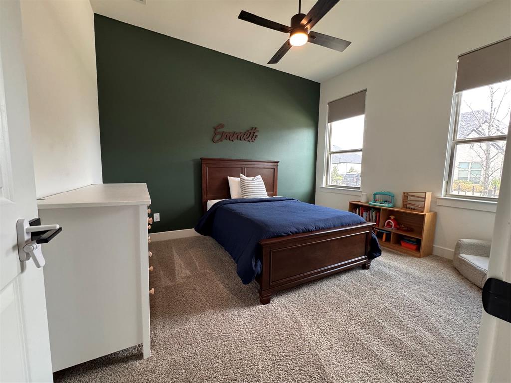 2429 Gallant Fox Road Celina, TX 75009 - Photo 21 of 39 a bedroom with a bed dresser and a window