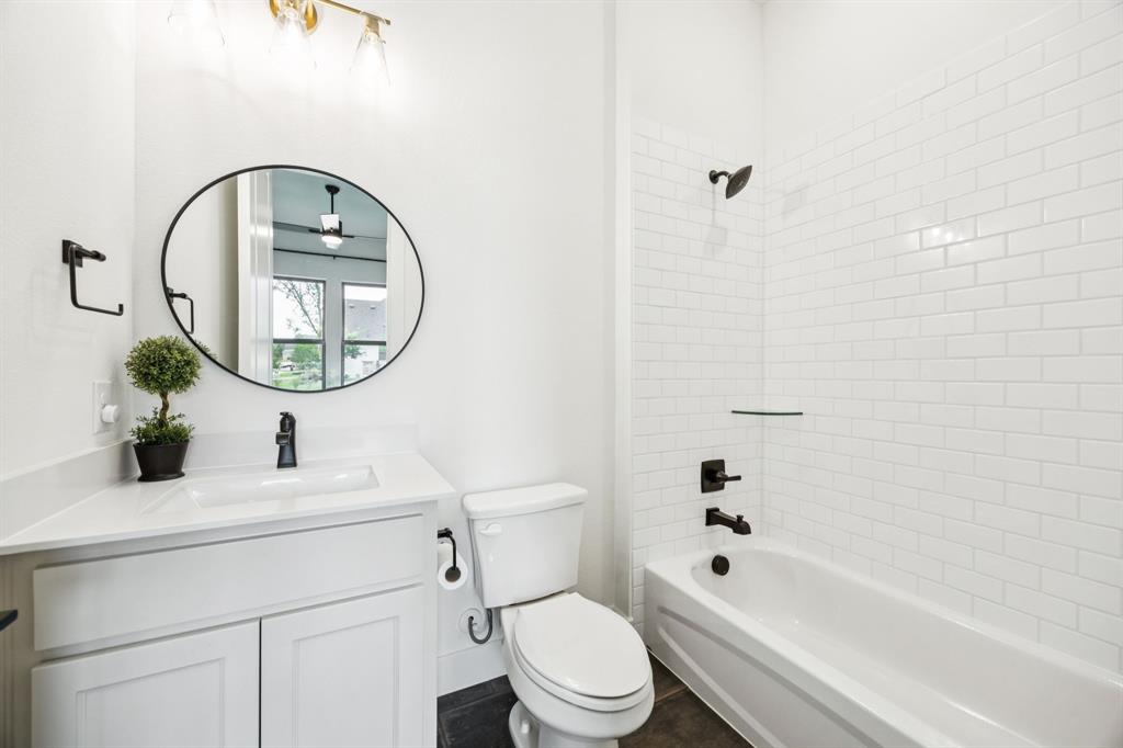 2429 Gallant Fox Road Celina, TX 75009 - Photo 26 of 39 a bathroom with a sink a toilet and a mirror