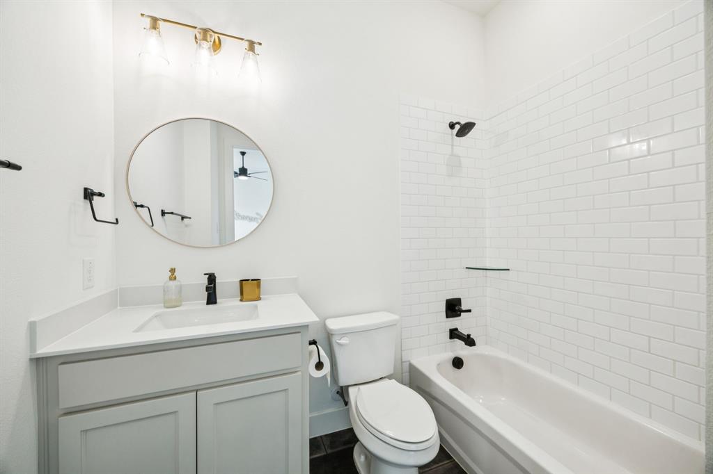 2429 Gallant Fox Road Celina, TX 75009 - Photo 27 of 39 a bathroom with a toilet sink vanity tub and shower