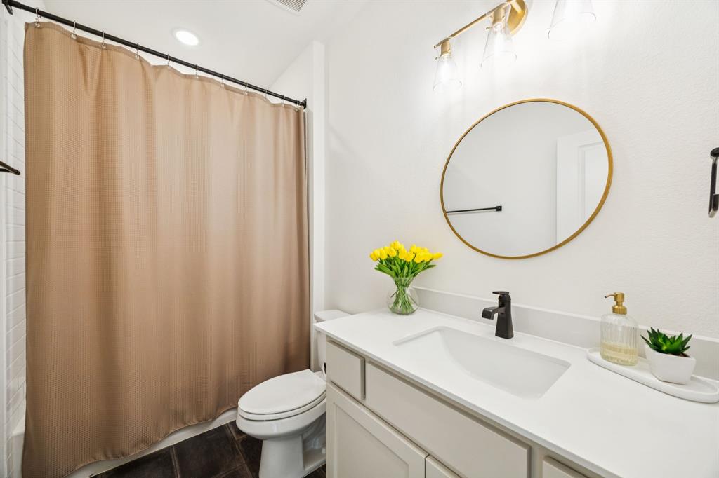 2429 Gallant Fox Road Celina, TX 75009 - Photo 31 of 39 a bathroom with a sink mirror vanity and toilet