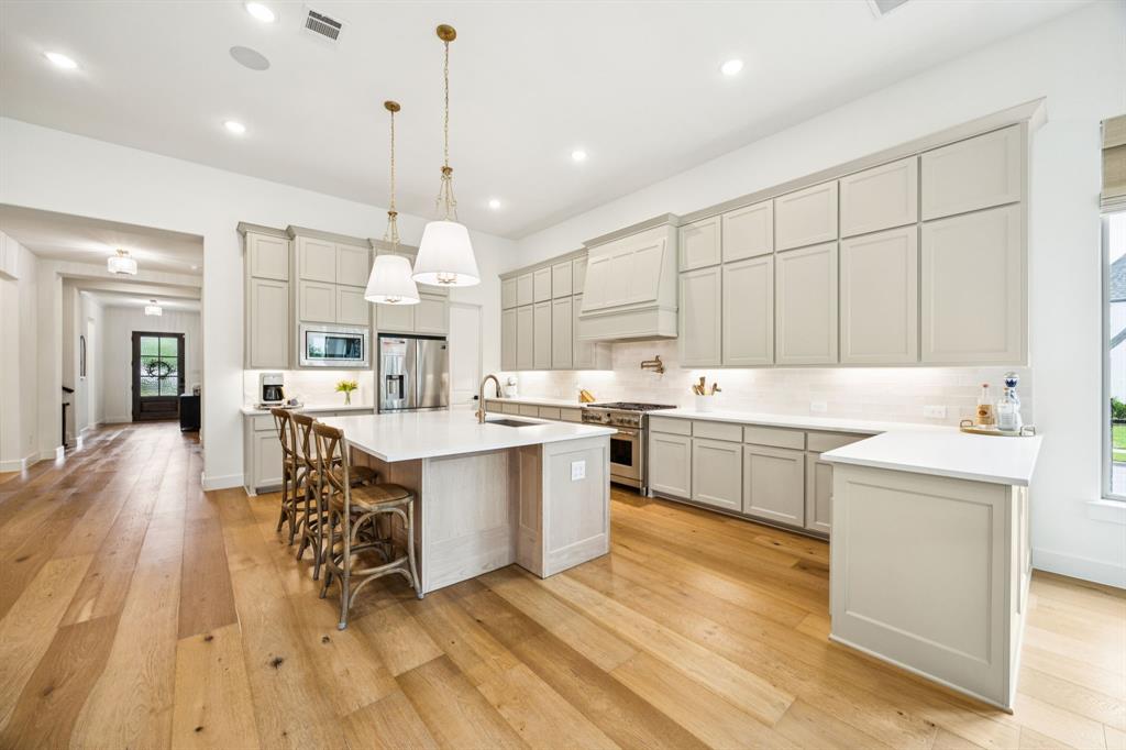 2429 Gallant Fox Road Celina, TX 75009 - Photo 5 of 39 a kitchen with a sink window and cabinets
