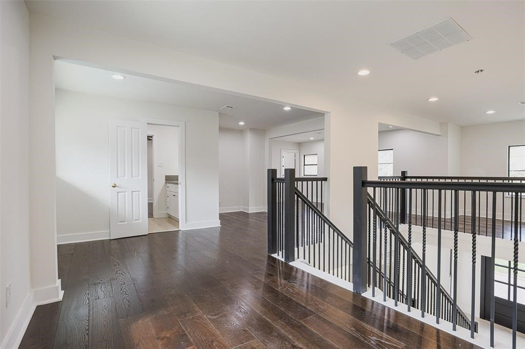 5614 Indian Circle Houston, TX 77056 - Photo 18 of 28 a view of a hallway with wooden floor