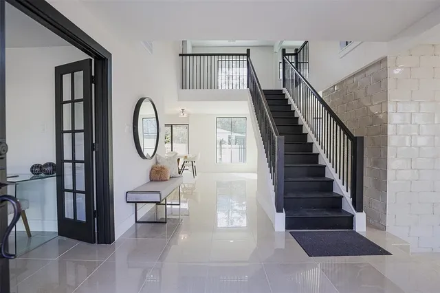 a view of a livingroom with furniture and entryway