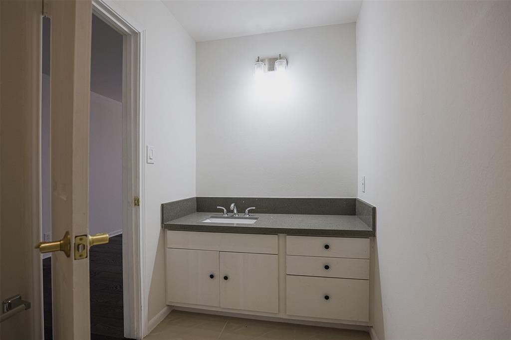 5614 Indian Circle Houston, TX 77056 - Photo 23 of 28 a bathroom with a granite countertop sink and vanity
