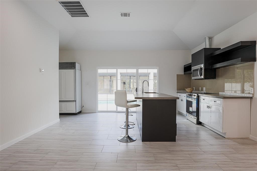 5614 Indian Circle Houston, TX 77056 - Photo 26 of 28 a kitchen with a refrigerator and a stove top oven