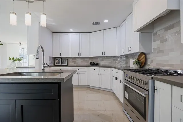 a kitchen with stainless steel appliances granite countertop a sink and cabinets