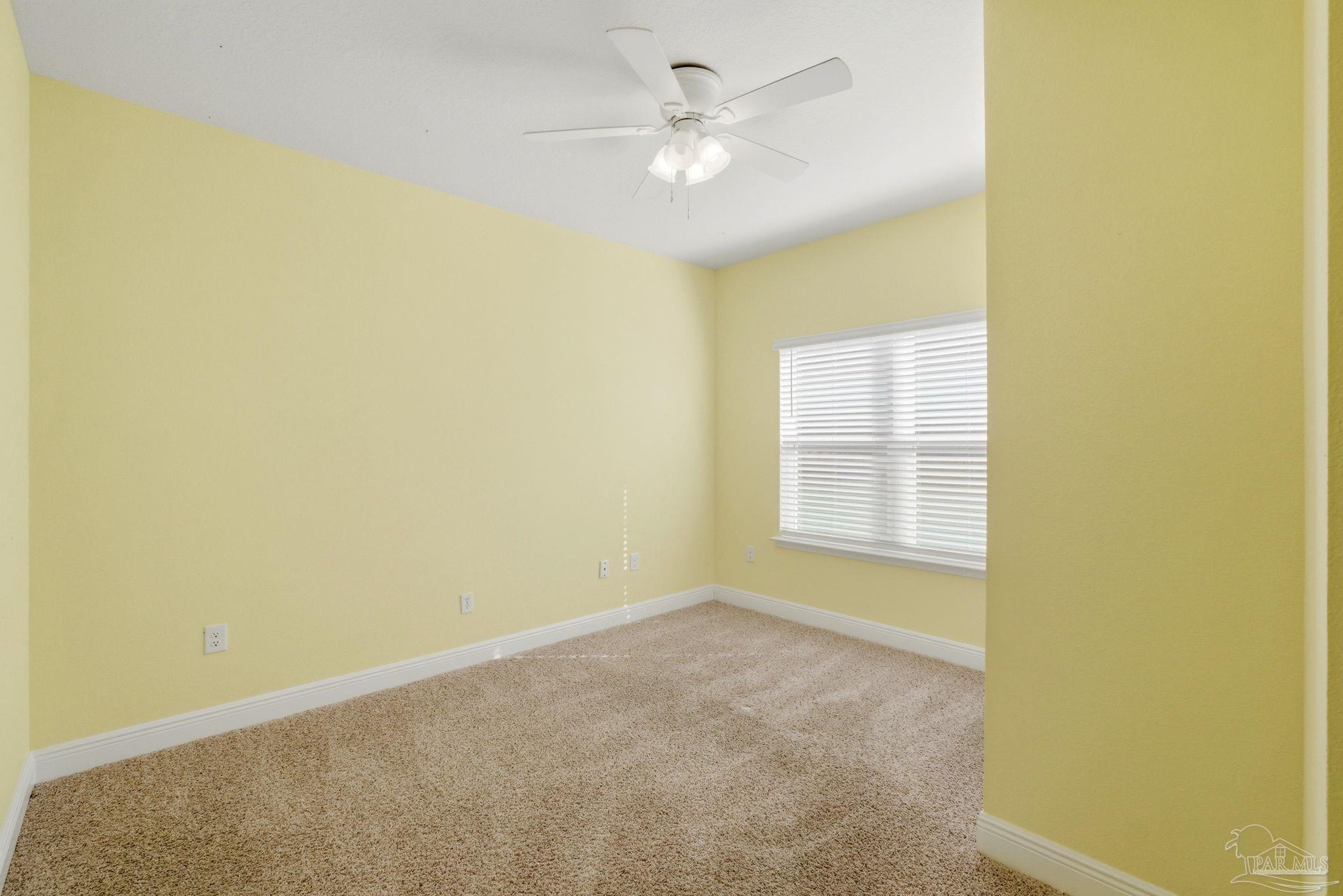 7829 Burnside Loop Pensacola, FL 32526 - Photo 16 of 34 an empty room with a window and a ceiling fan