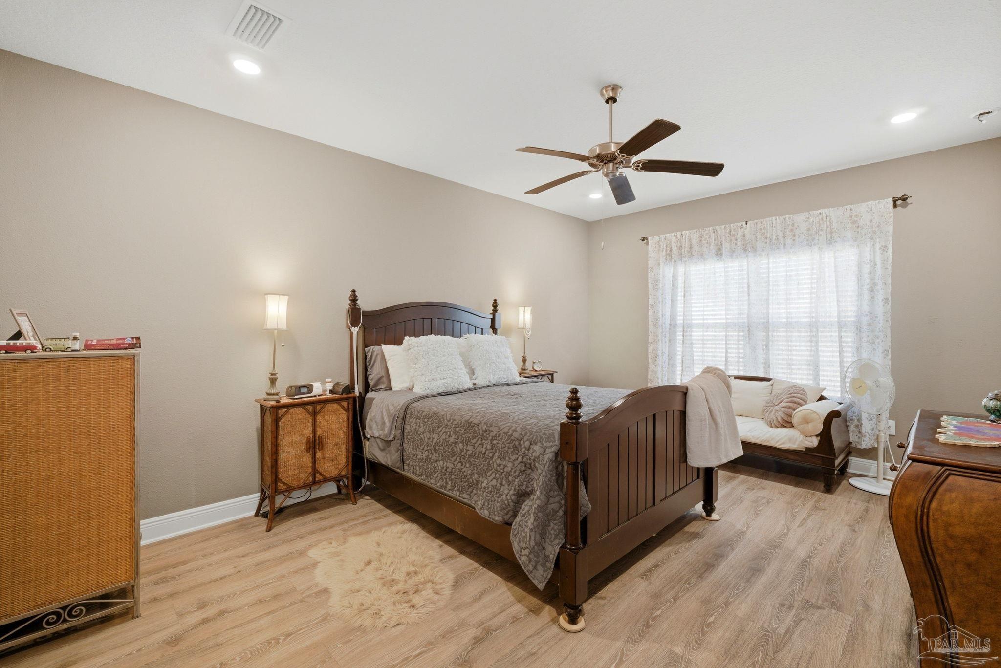 7829 Burnside Loop Pensacola, FL 32526 - Photo 18 of 34 a bedroom with a bed chandelier and a window