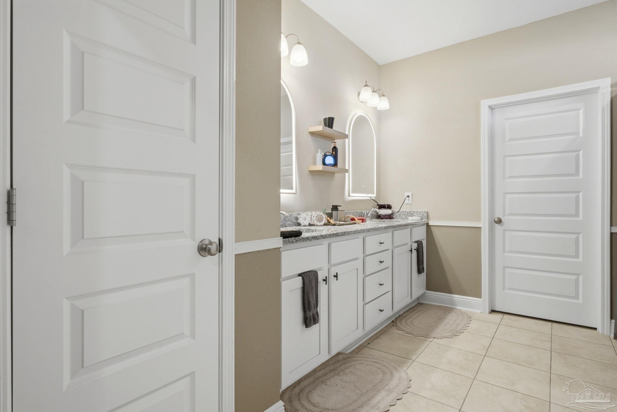 7829 Burnside Loop Pensacola, FL 32526 - Photo 21 of 34 a spacious bathroom with a mirror and a sink