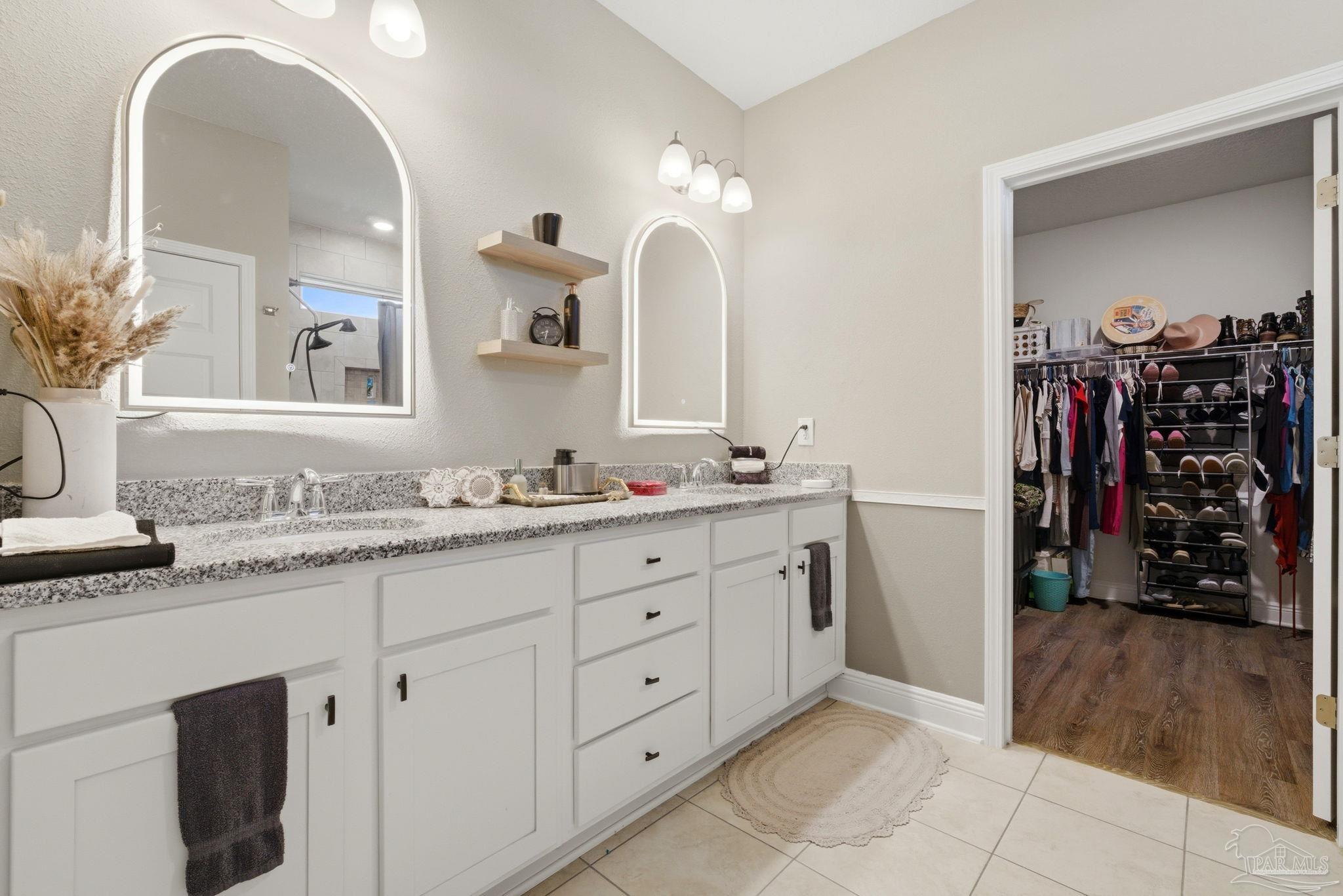 7829 Burnside Loop Pensacola, FL 32526 - Photo 22 of 34 a spacious bathroom with a double vanity sink and a mirror