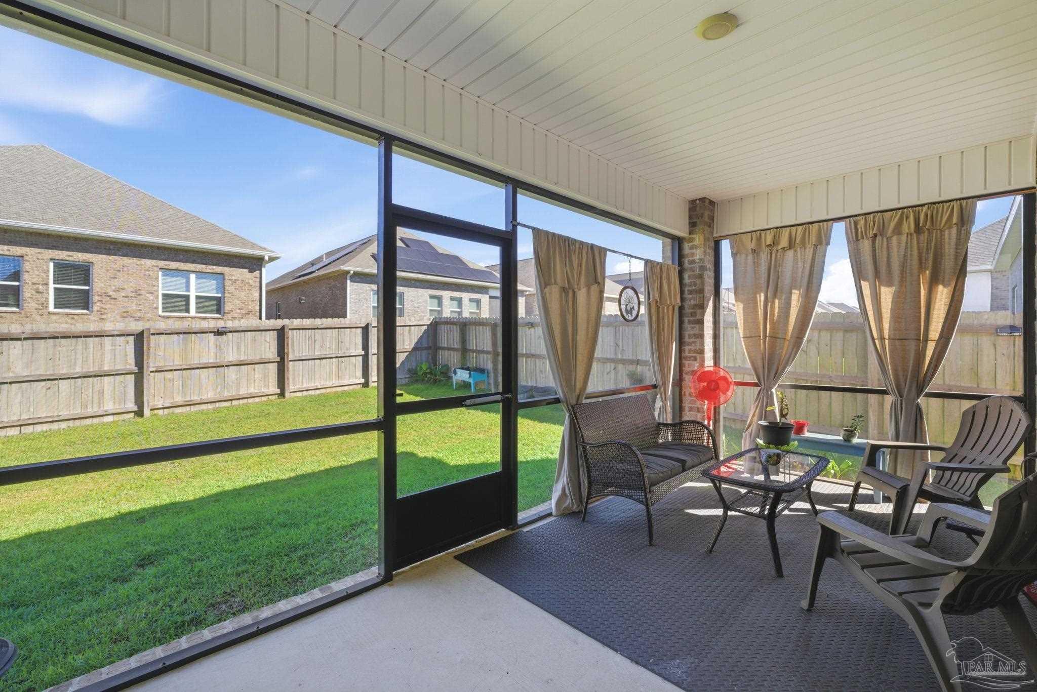 7829 Burnside Loop Pensacola, FL 32526 - Photo 28 of 34 a living room with furniture and a floor to ceiling window