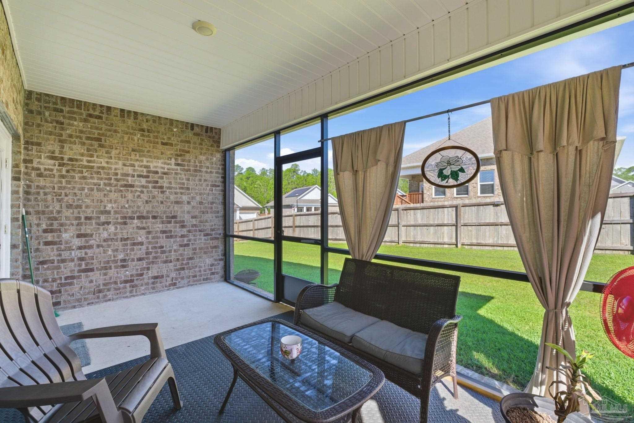 7829 Burnside Loop Pensacola, FL 32526 - Photo 29 of 34 a view of a chairs and table in a patio