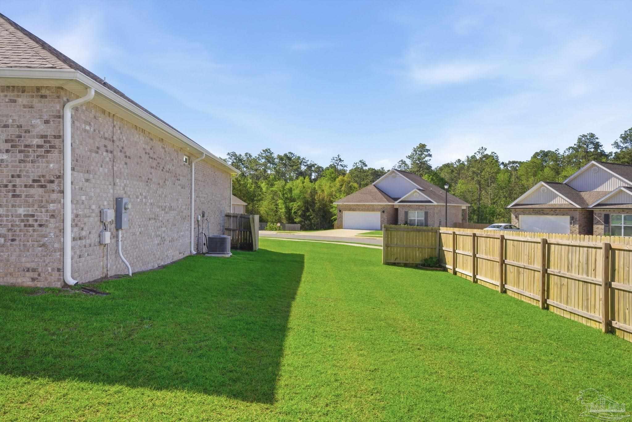 7829 Burnside Loop Pensacola, FL 32526 - Photo 32 of 34 a view of a backyard with potted plants and large tree
