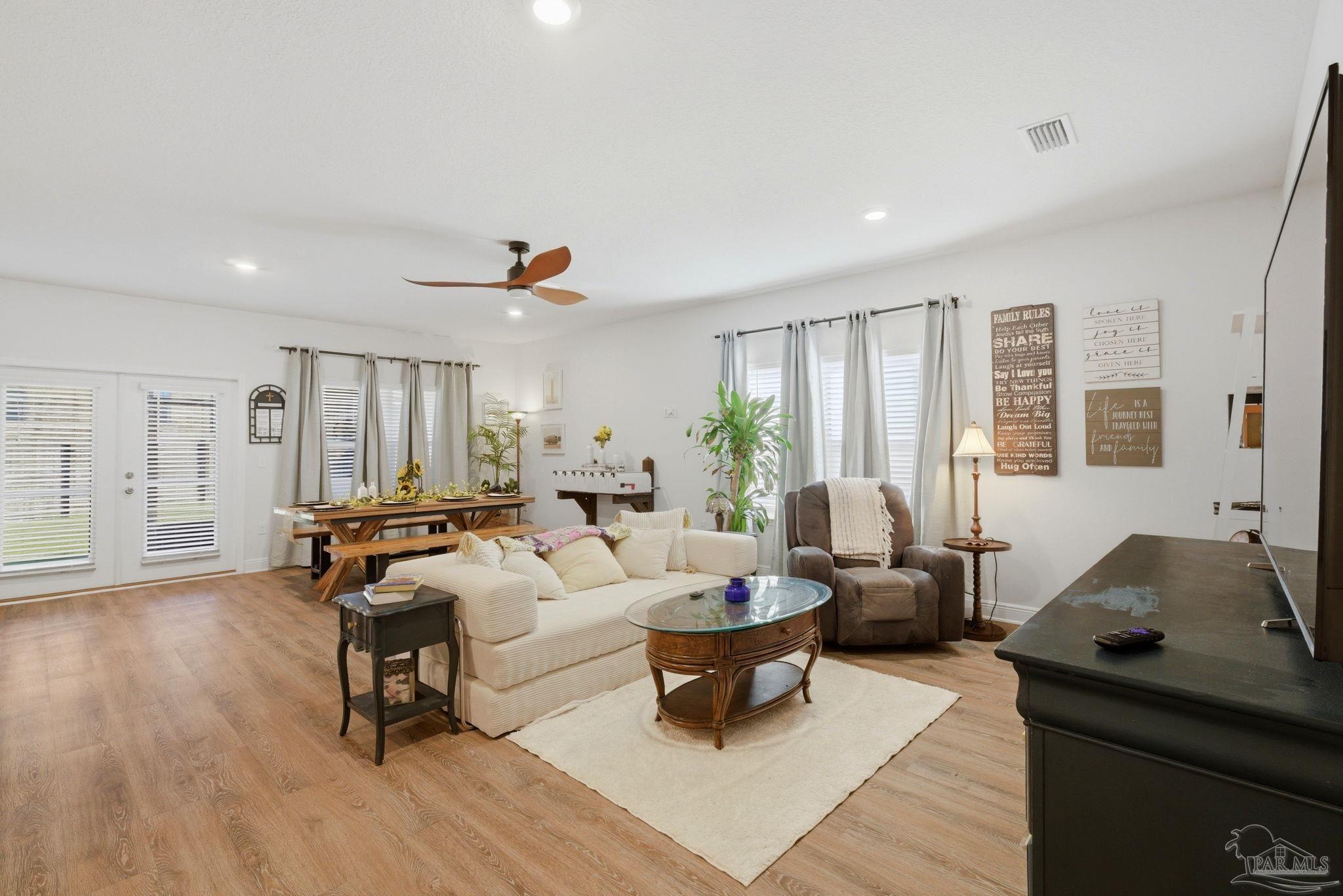 7829 Burnside Loop Pensacola, FL 32526 - Photo 7 of 34 a living room with furniture and wooden floor