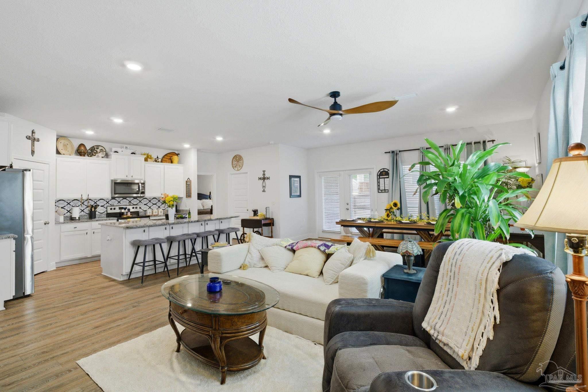 7829 Burnside Loop Pensacola, FL 32526 - Photo 8 of 34 a living room with furniture a window and kitchen view