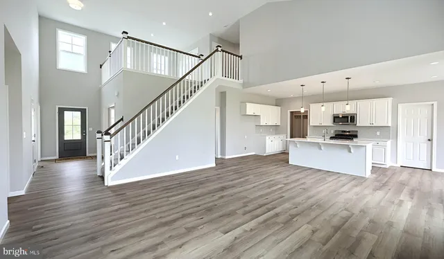 a view of kitchen with wooden floor and electronic appliances