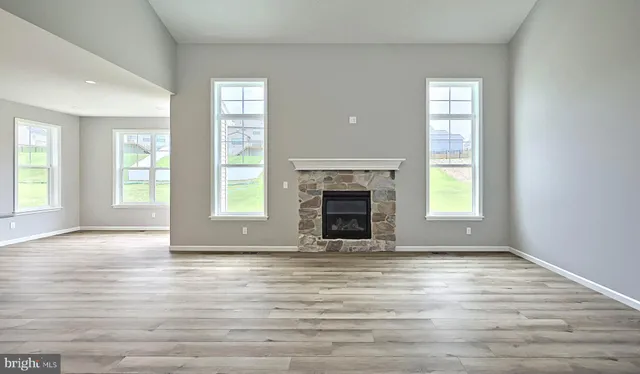 an empty room with wooden floor and a window