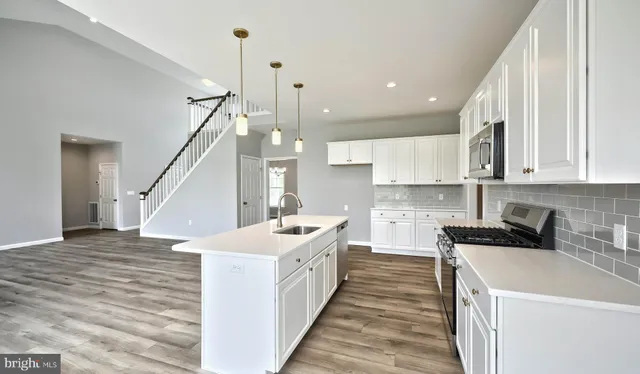 a kitchen with a sink a counter top space and cabinets