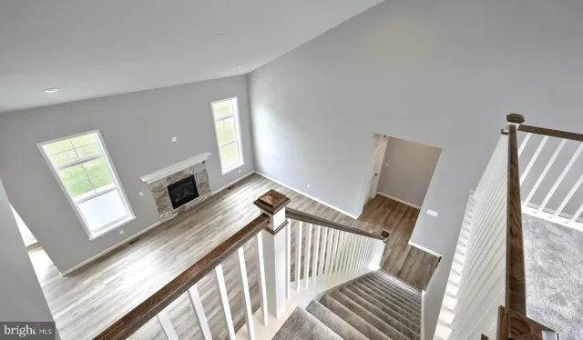 a view of a livingroom with furniture wooden floor and staircase