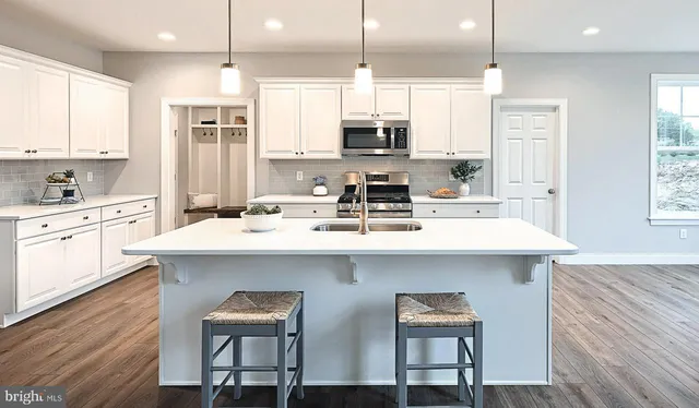 a kitchen with a sink cabinets and window