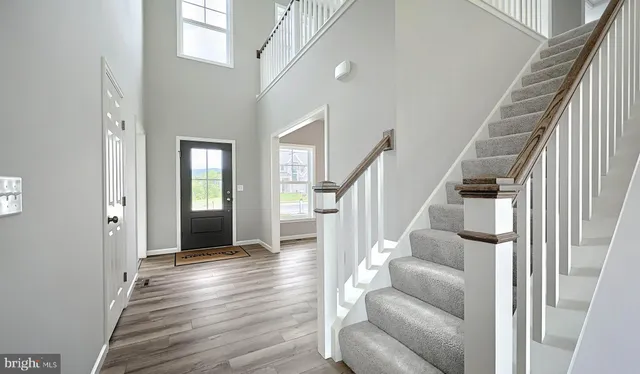 a view of entryway and hall with wooden floor