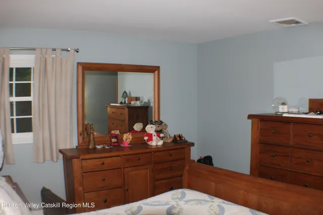 a room with a dresser and mirror