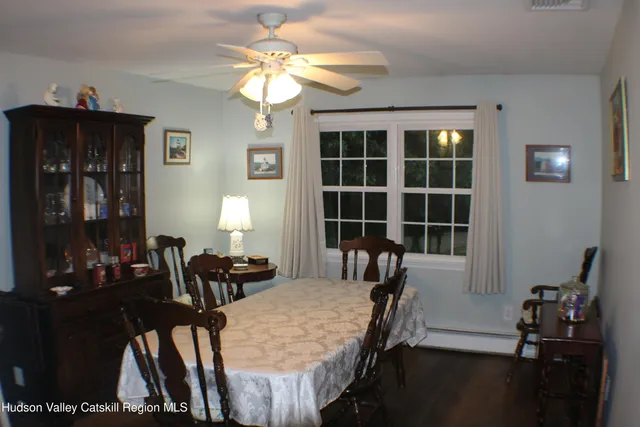 a view of a dining room with furniture and chandelier