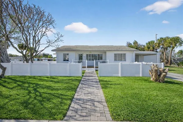 a front view of a house with yard patio and green space