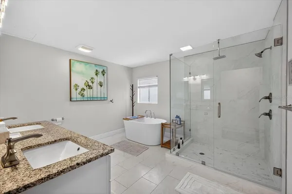 a bathroom with a granite countertop sink a toilet and shower