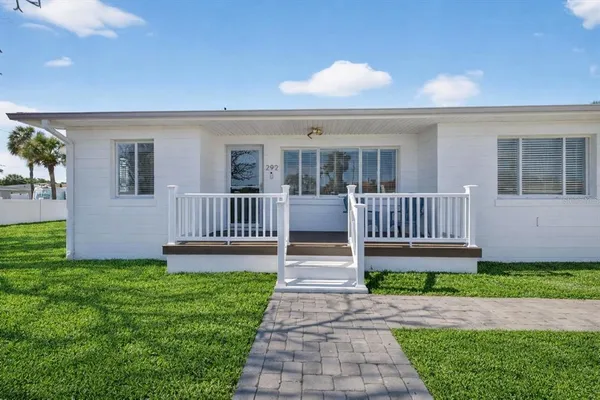a view of a house with a yard and deck