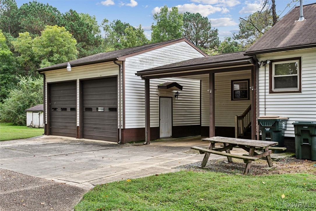 456 Queens Creek Road Williamsburg, VA 23185 - Photo 35 of 44 a front view of a house with a garden and bench