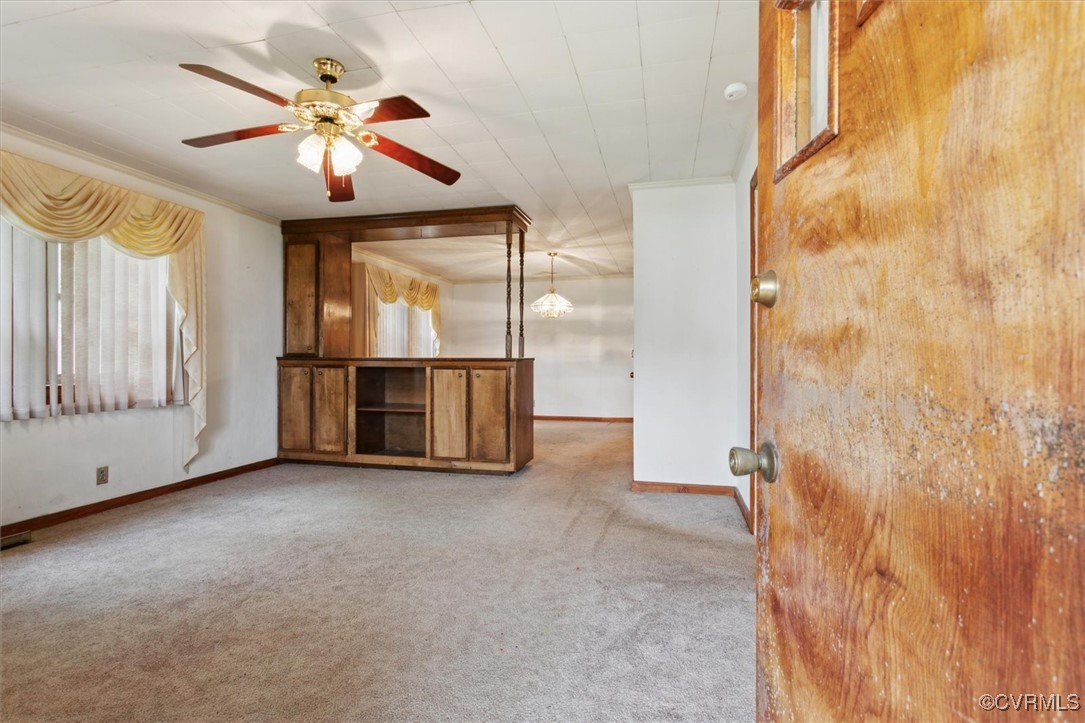 456 Queens Creek Road Williamsburg, VA 23185 - Photo 4 of 44 an empty room with chandelier fan and windows