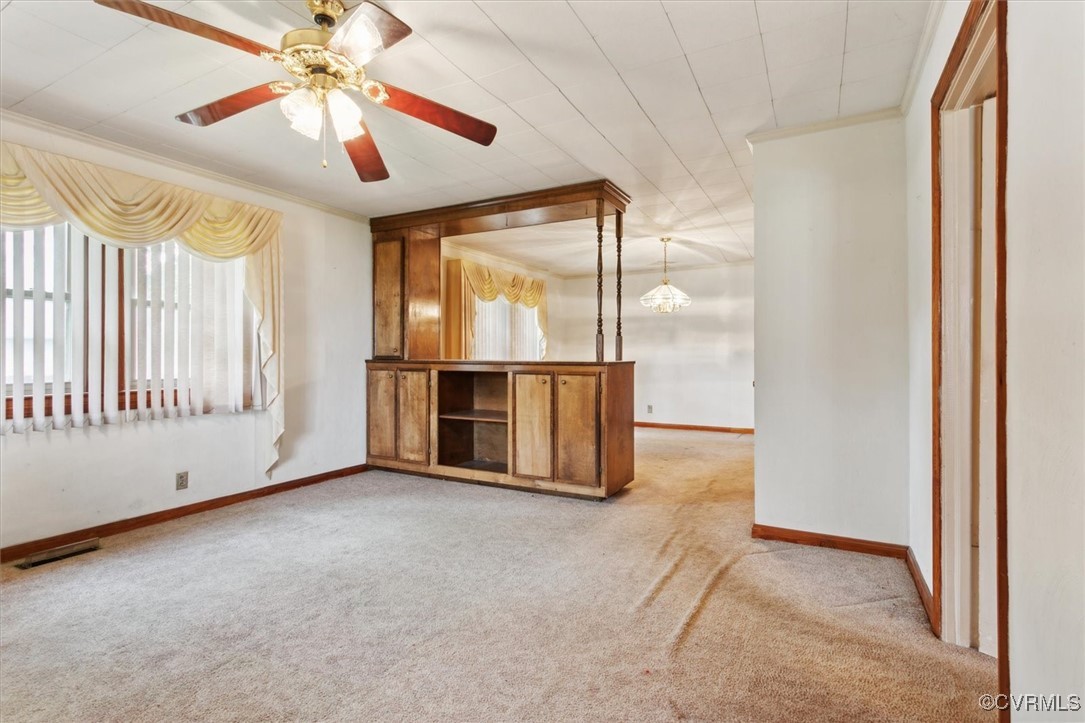 456 Queens Creek Road Williamsburg, VA 23185 - Photo 7 of 44 an empty room with chandelier fan and windows
